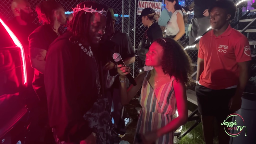 Kendrick Lamar holding a microphone in an interview with Jazzy after his performance at Rolling Loud 2022.