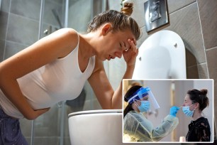 Young woman feeling sick and leaning on toilet. Teenage Girl Feeling Unwell In Bathroom Kneeling By Toilet. Side view of sick woman in pajama holding hand on her stomach while leaning on the toilet