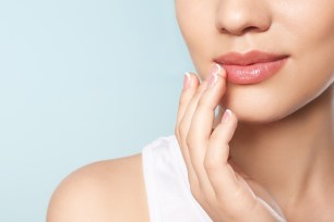 Closeup of a young woman's lips on a colored background