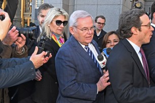 Senator Bob Menendez and his wife Nadine (pictured) leave federal court after being charged .