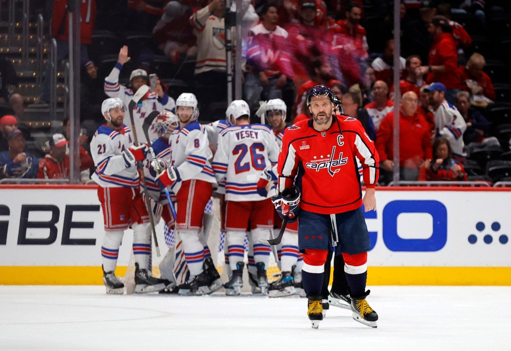 Rangers celebrate as Alex Ovechkin #8 of the Washington Capitals skates off at the end the game on Sunday.