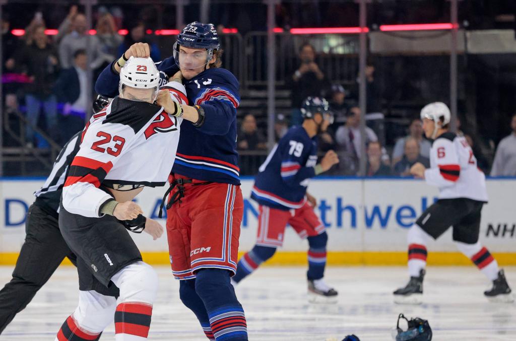 A scuffle breaks out between New York Rangers center Matt Rempe #73 and New Jersey Devils defenseman Kurtis MacDermid #23 as will as three other sets of players as soon as the puck drops during the first period.