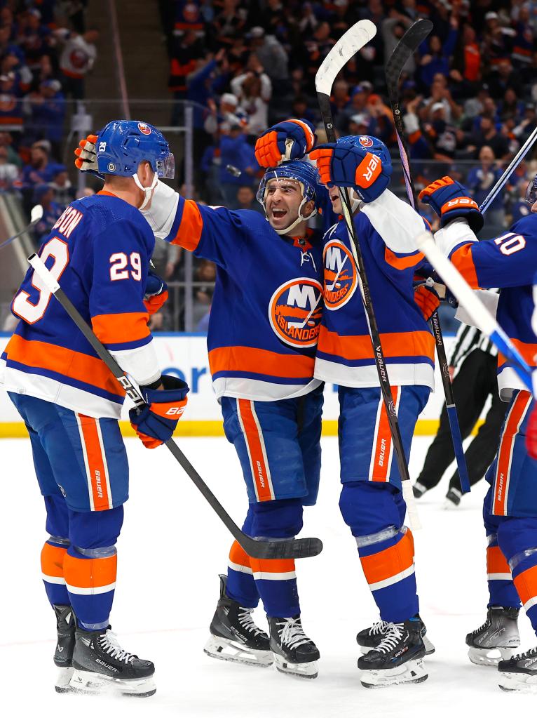 New York Islanders center Kyle Palmieri (21) celebrates with teammates after scoring a goal against the New York Rangers