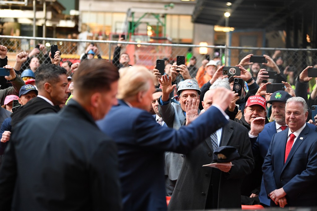 People react as Republican presidential candidate and former U.S. President Donald Trump meets with Union workers.
