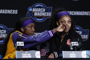 Angel Reese right, and Flau'jae Johnson of the LSU Tigers speak with the media after losing to the Iowa Hawkeyes in the Elite 8 round of the NCAA Women's Basketball Tournament at MVP Arena on April 1, 2024 in Albany, New York. 