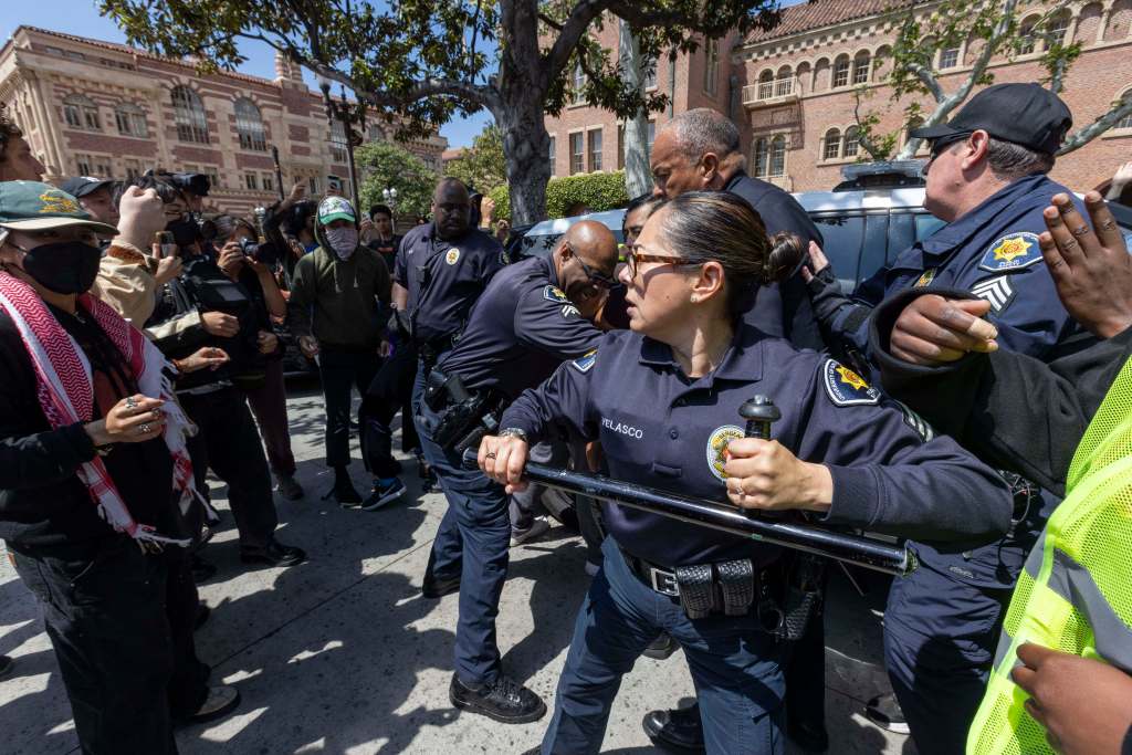 Public safety officers confront protestors at Alumni Park at USC on April 24, 2024.