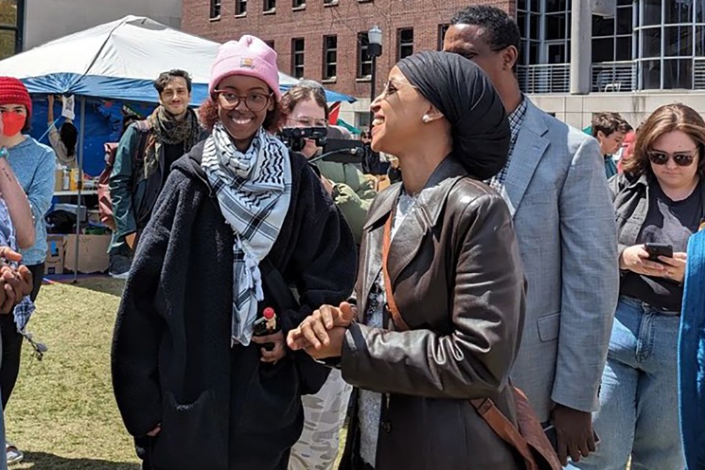 Rep. Ilhan Omar and her daughter, Isra Hirsi, smiling and interacting with the crowd at the anti-Israel encampment at Columbia University