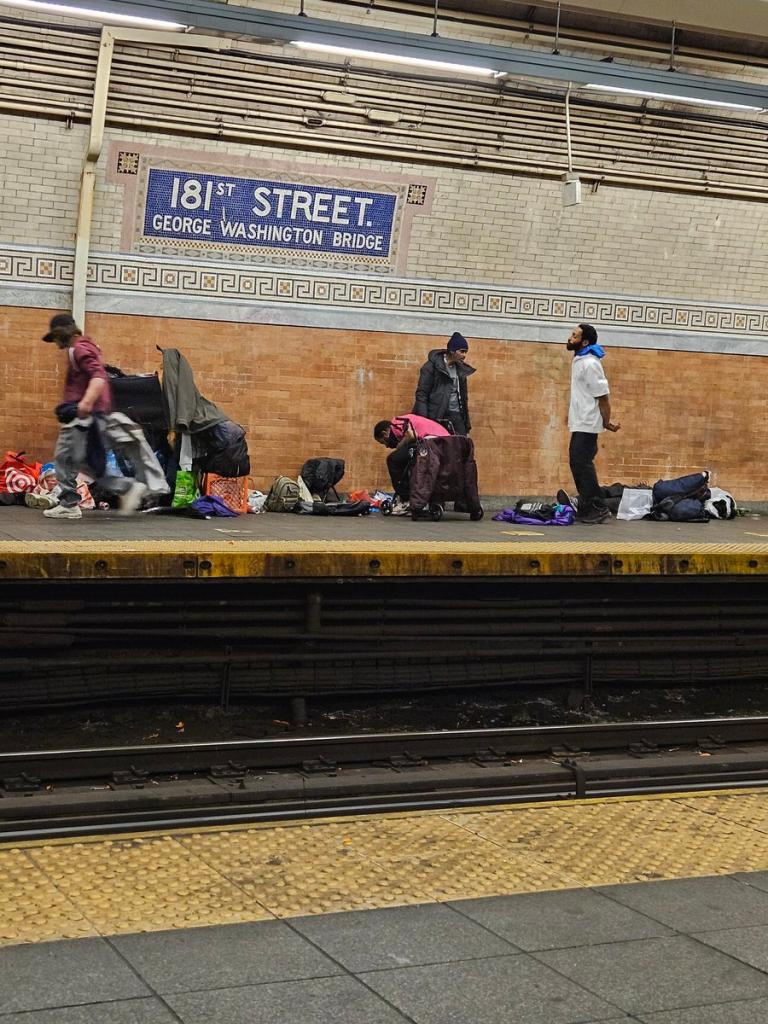 Drug users standing on a train platform.