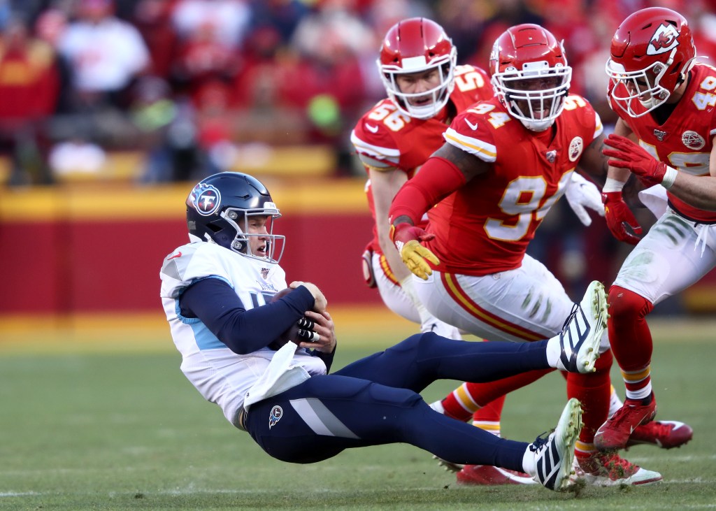 Ryan Tannehill #17 of the Tennessee Titans is tackled after scrambling against Terrell Suggs #94 and Daniel Sorensen #49 of the Kansas City Chiefs in the AFC Championship Game at Arrowhead Stadium on January 19, 2020 in Kansas City, Missouri.  