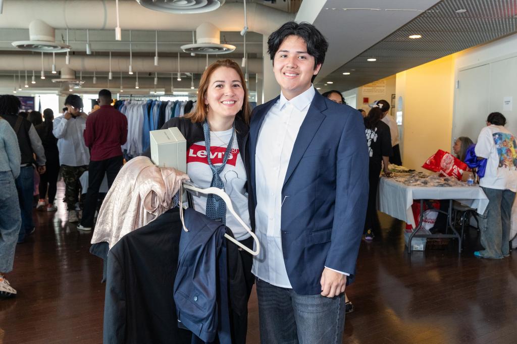 17-year-old Dylan and his mom selecting a suit at the Operation Prom clothing giveaway event at the Dominican Community Center, New York
