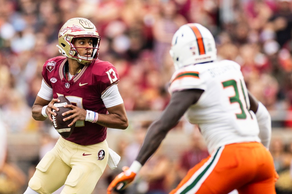 ordan Travis #13 of the Florida State Seminoles looks to pass during the first half of a game against the Miami Hurricanes at Doak Campbell Stadium on November 11, 2023 in Tallahassee, Florida. 