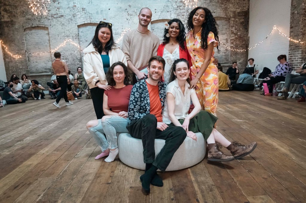 Group photo of the Gaia Music Collective choir performance with Veena Kumaravel and a 180 person audience in a vacant space in Gowanus, Brooklyn NY.