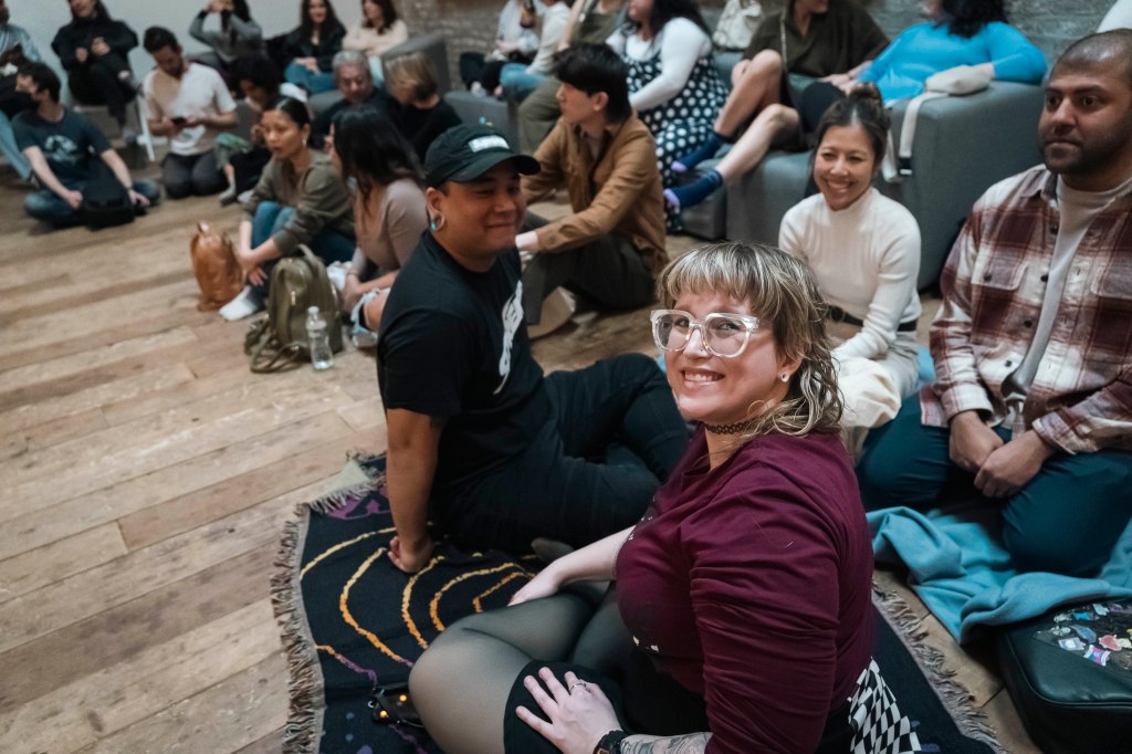 Gaia Music Collective choir performing to an international audience of 180 people seated on the floor, at a vacant space in Gowanus area, Brooklyn NY.