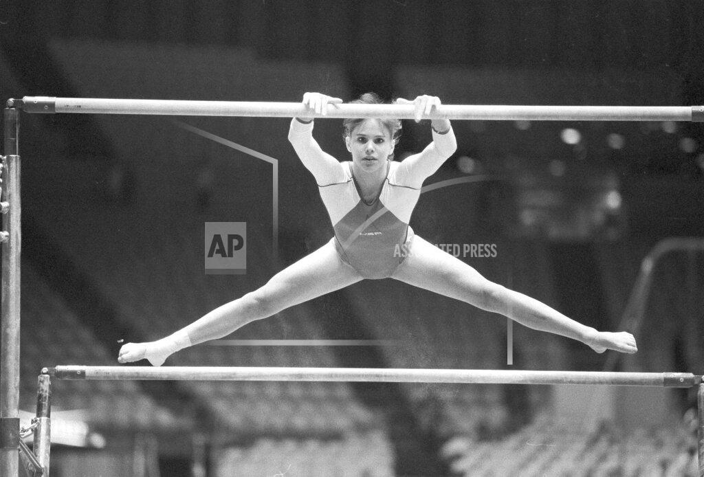 Former elite gymnast, Jennifer Sey, at 16, warms up on the uneven bars.