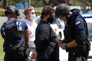 Protesters calling for a cease-fire in support of Gaza are arrested after blocking northbound traffic, Monday, April 15, 2024, in downtown Miami.