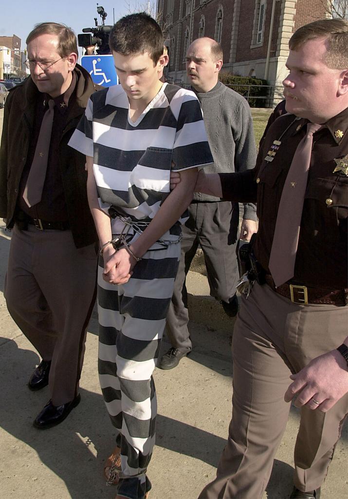 James Parker, 16, is led to the Henry County Courthouse in New Castle, Indiana on Feb. 20, 2001 after being arrested weeks after the killings.