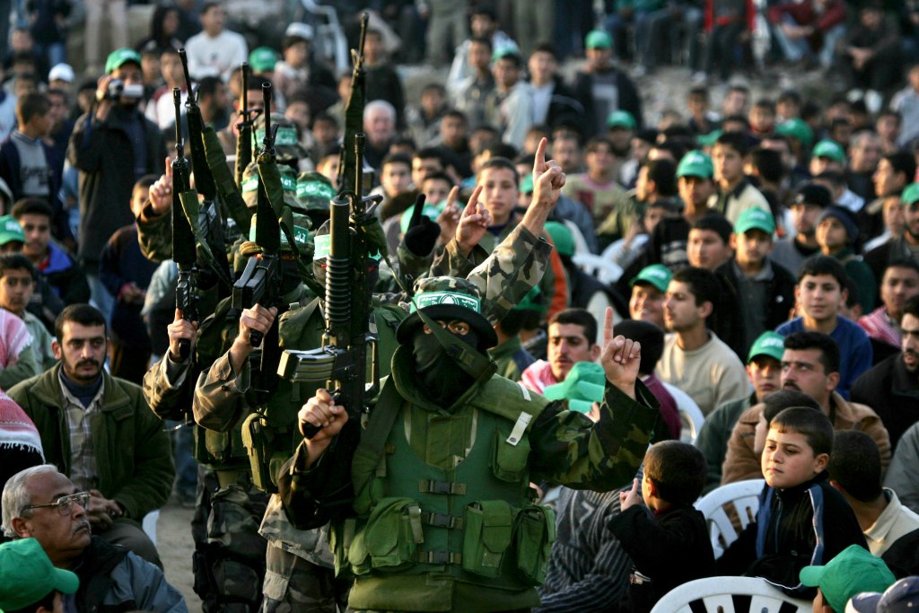 Masked Palestinian Hamas fighters marching in an honouring ceremony for fallen comrades in Deir Al-Balah refugee camp, Gaza Strip, in February 2005