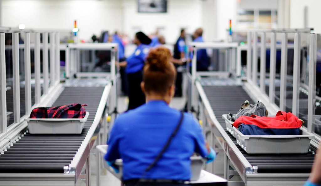 A TSA watching security line. 