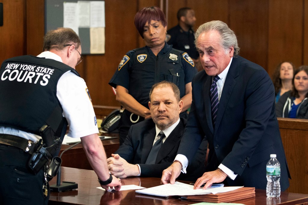 Harvey Weinstein seated in court with his attorney Benjamin Brafman, discussing with a court officer, New York, June 5, 2018.