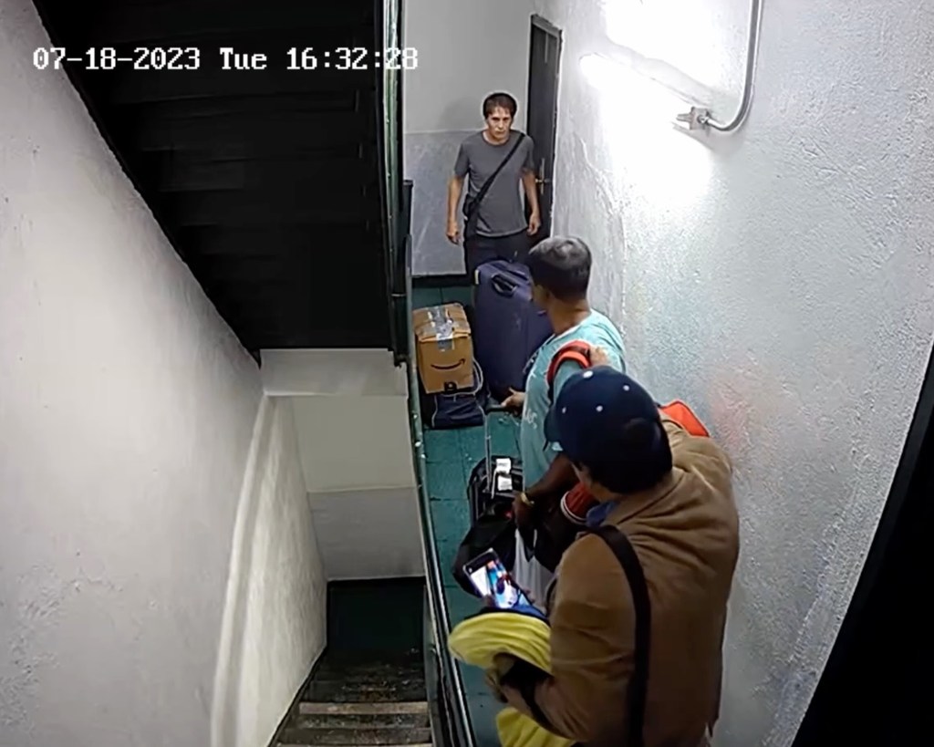 Screen grab of Thor Boucher in Essex Street apartment with men in hallway