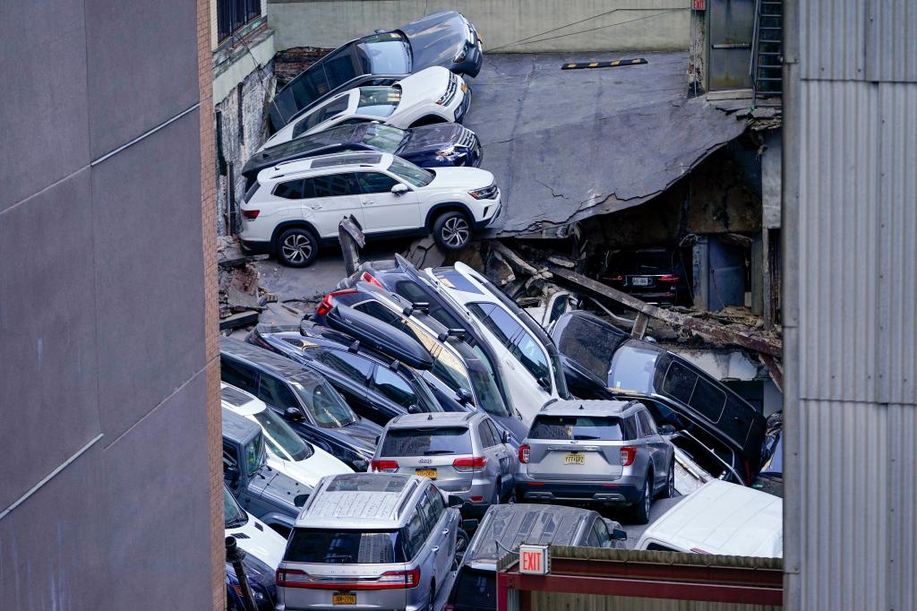 Cars are seen piled on top of each other at the scene of a partial collapse of a parking garage in the Financial District in New York.