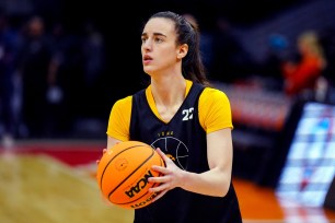 Iowa Hawkeyes guard Caitlin Clark in black and yellow uniform practicing basketball at Rocket Mortgage FieldHouse before the Final Four.