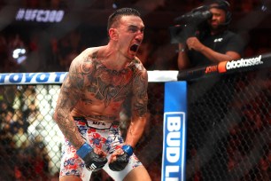 Max Holloway celebrates after knocking out Justin Gaethje during UFC 300 at T-Mobile Arena. 