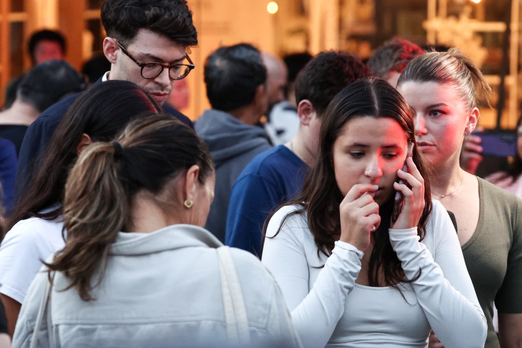 People reacting to a stabbing incident outside Westfield Bondi Junction shopping mall in Sydney, April 13, 2024