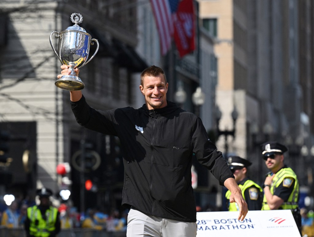 Rob Gronkowski holds the Boston Marathon trophy at the finish line on April 15, 2024, in Boston. Gronkowski is grand marshal of the race.  