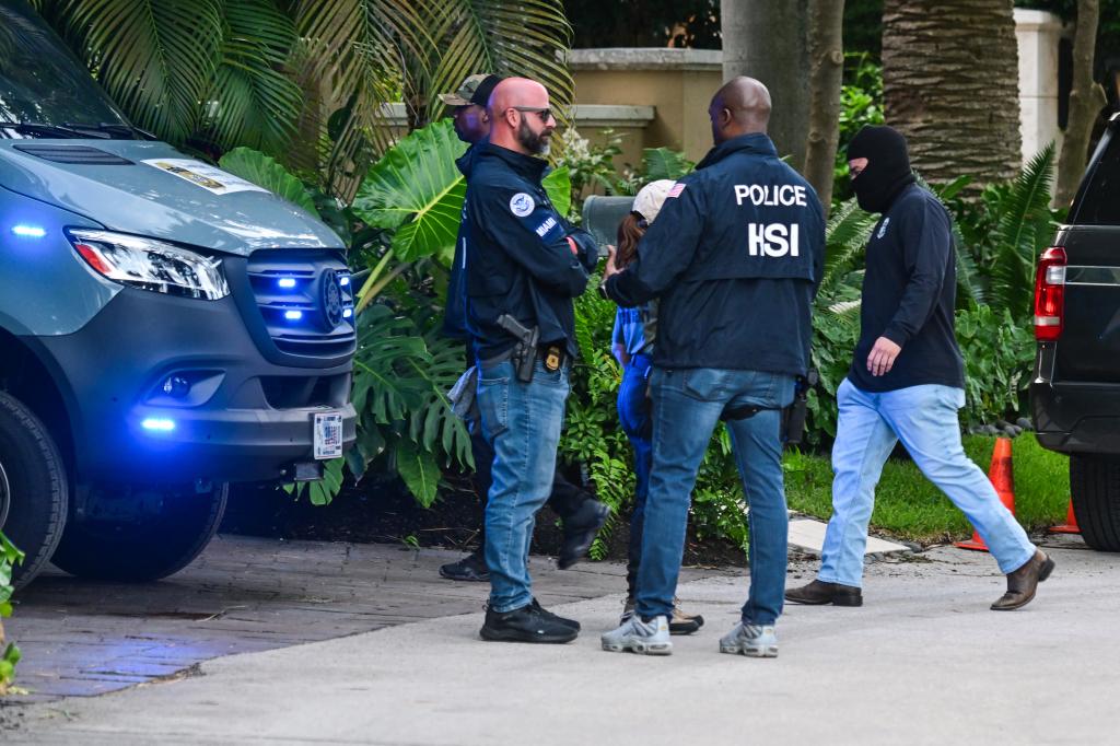 Federal and Homeland Security Investigation agents are seen at the entrance of Sean "Diddy" Combs's home at Star Island in Miami Beach on March 25, 2024.