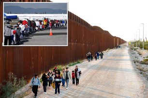 Group of asylum seekers walking towards U.S. Customs and Border Protection officers after crossing the U.S.-Mexico border wall in Lukeville, Arizona.