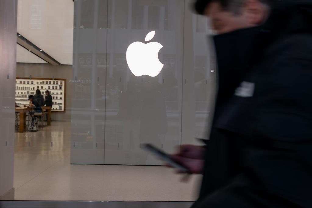 People walking past an Apple store in a shopping mall in lower Manhattan, New York City, on February 01, 2024.