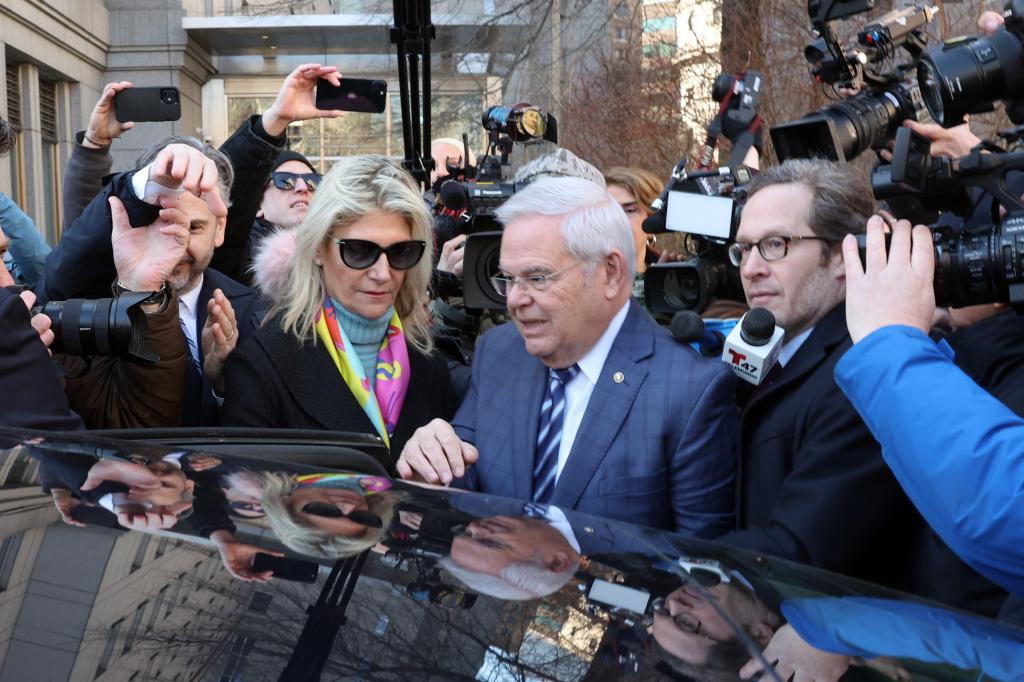 Nadine Arslanian and Robert Menendez surrounded by reporters in front of a Manhattan court house.