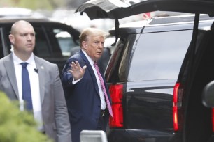 Former President Donald Trump in a suit and tie exiting his Manhattan residence