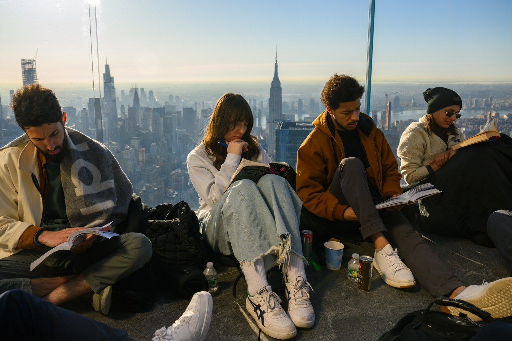 People participate in an early morning reading party hosted by Reading Rhythms and Edge on World Book and Copyright Day at Edge at Hudson Yards on April 23, 2024.