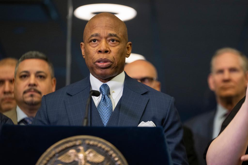 Mayor Eric Adams in a suit and tie standing at a podium during a news conference concerning the 2024 New York earthquake at the City Emergency Management Department