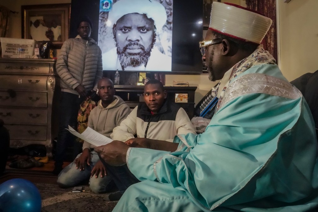 Imam Omar Niass advising migrants from Senegal on how to apply for city services at Masjid Ansaru-Deen mosque in the Bronx on March 15, 2024.