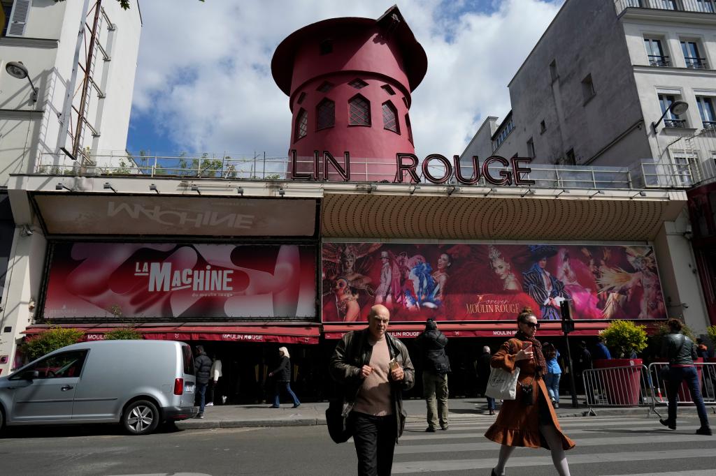 The sails of the landmark red windmill atop the Moulin Rouge, the most celebrated cabaret club in Paris, fell to the ground overnight in the early hours of Thursday.