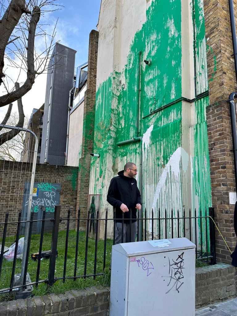 Newly surfaced pictures show a man some believe to be Banksy at the scene of his latest mural in London.