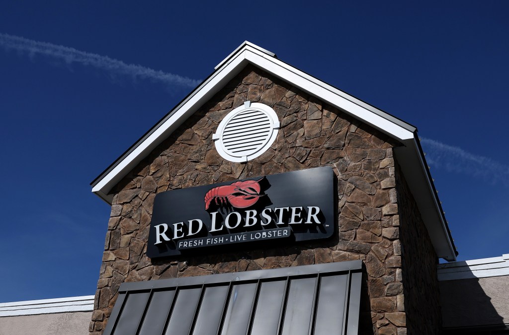 Sign posted on the exterior of a Red Lobster restaurant in Rohnert Park, California, signalling potential bankruptcy due to rising debts and labor costs.
