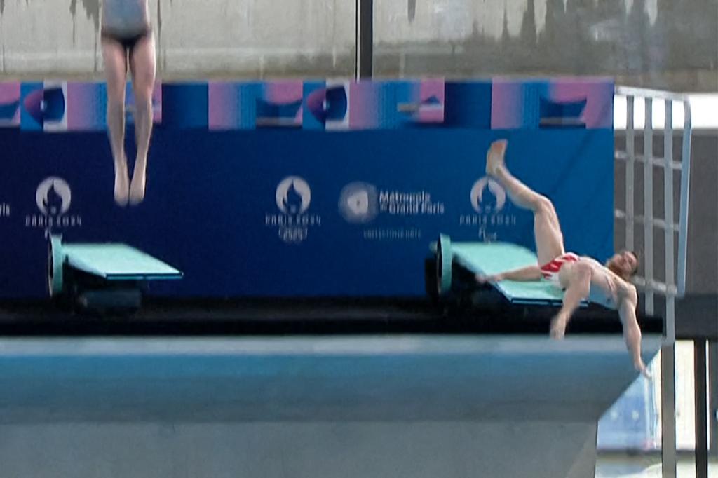 This grab from a video handout by the Metropole du Grand Paris authority on April 4, 2024 shows French diver Alexis Jandard, who has qualified for the Paris Games, falling while diving during a demonstration alongside two qualified French divers