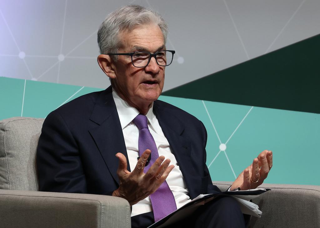Federal Reserve Bank Chair Jerome Powell, dressed in a suit and tie, speaking at the Stanford Business, Government and Society Forum on interest rate decisions.