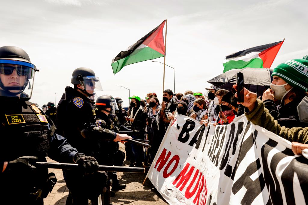 Law enforcement officers face off against protestors block traffic in the Bay area on April 15, 2024.