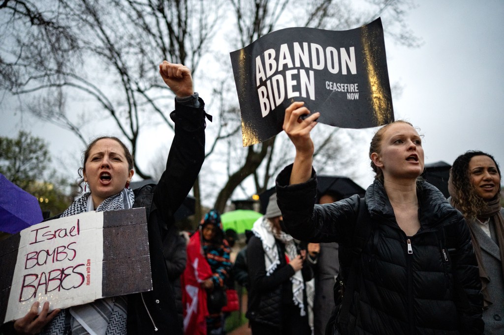 Pro-Palestinian demonstrators holding signs, calling for a ceasefire in Gaza during a protest outside the White House