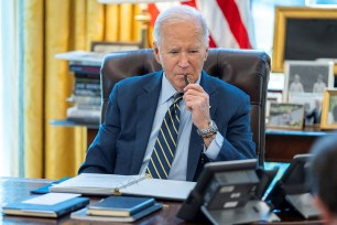 President Joe Biden speaks on the phone with Israeli Prime Minister Benjamin Netanyahu in this White House handout image taken in the Oval Office.