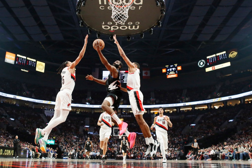 LA Clippers shooting guard James Harden (1) shoots the ball against Portland Trail Blazers forward Kris Murray (8, right) and guard Dalano Barton (5) during the first half at Moda Center.