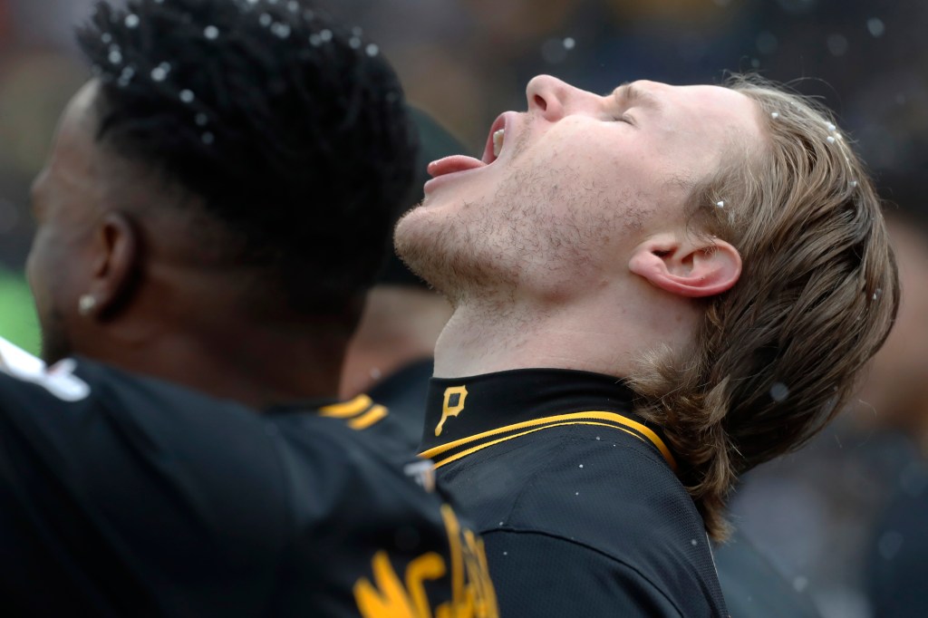 Pittsburgh Pirates left fielder Jack Suwinski (right) attempts to catch snow flakes on his tongue during the second inning against the Baltimore Orioles at PNC Park.