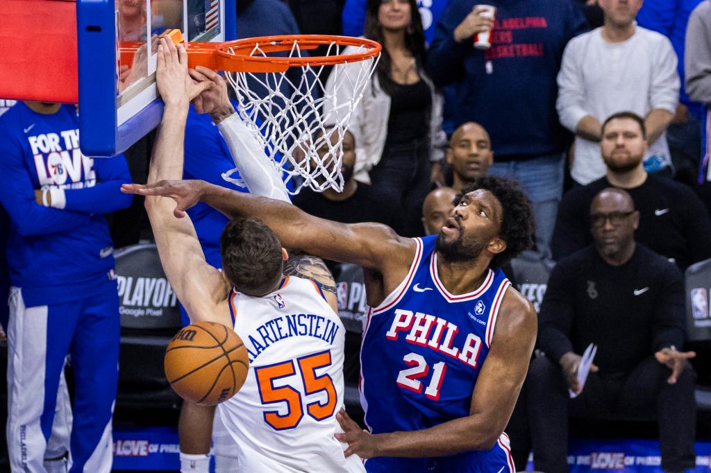 Joel Embiid #21 of the Philadelphia 76ers blocks Isaiah Hartenstein #55 of the New York Knicks during the second half. 