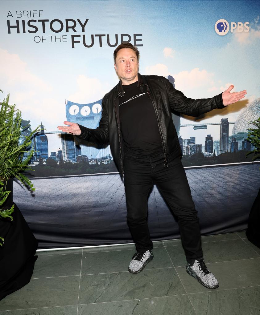 Elon Musk standing in front of a poster at 'A Brief History Of The Future' New York Screening, The Celeste Bartos Theater at Museum of Modern Art