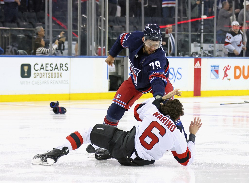 K'Andre Miller #79 of the New York Rangers fights with John Marino #6 of the New Jersey Devils during the first period at Madison Square Garden